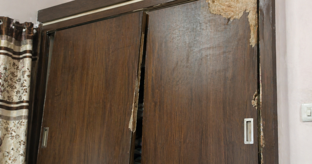 wooden wardrobe swelling monsoon Hyderabad - moisture damage wardrobe door not closing
